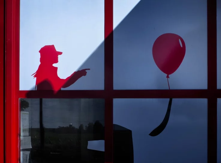  a supermarket wall photographed in Casale, a sticker of a woman with a balloon, a woman with a balloon, 